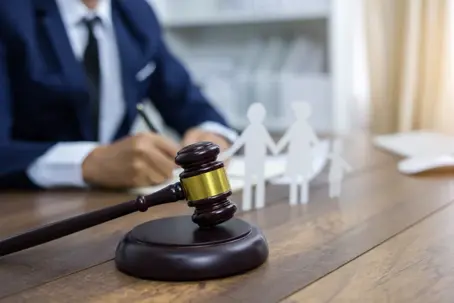 Family figure and gavel on table