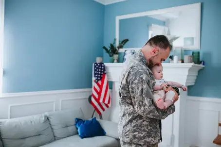 A soldier holds his baby son