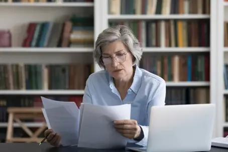 Woman looking at documents in hand
