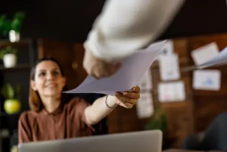 Women handing over documents