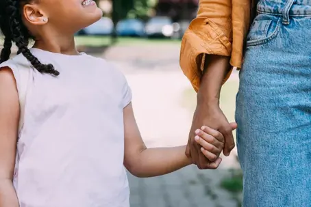 Child holding parent's hand