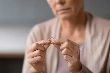 Woman taking off wedding ring