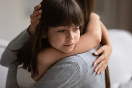 Little girl hugging adult women
