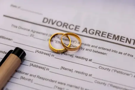 Wedding rings on top of divorce papers