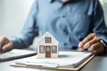 Toy house on top of documents