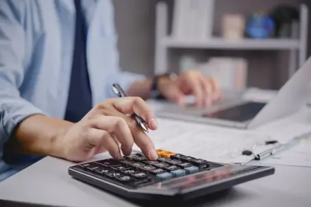 Man typing on his calculator