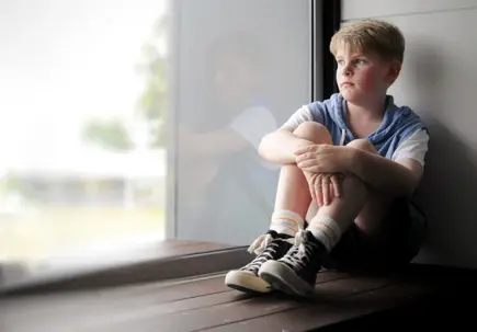 Little boy staring out the window