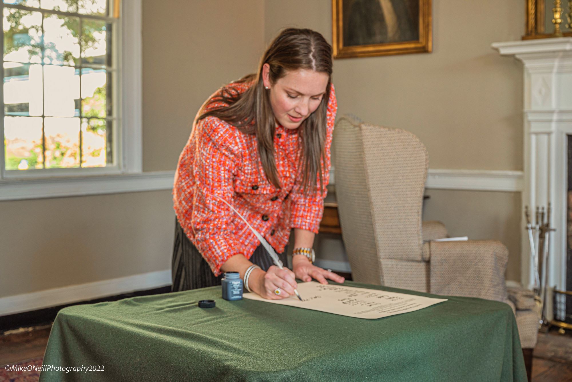 Woman Signing Her Name on a Legal Document