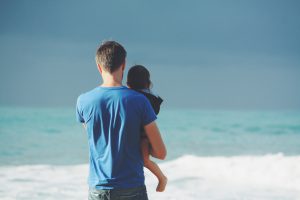 Father & son in front of the sea